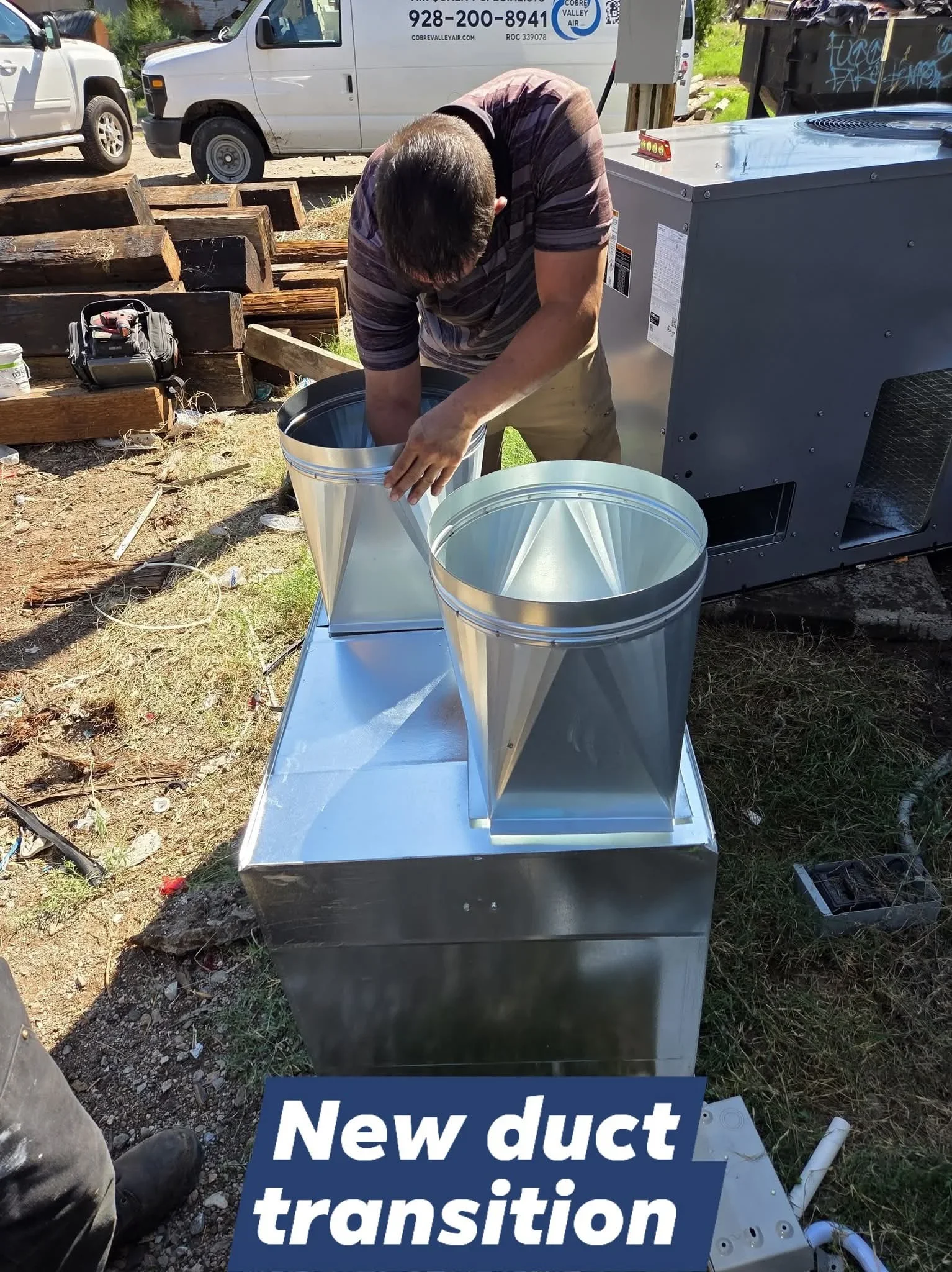 Technician installing galvanized steel HVAC duct transition with sealed metal joints